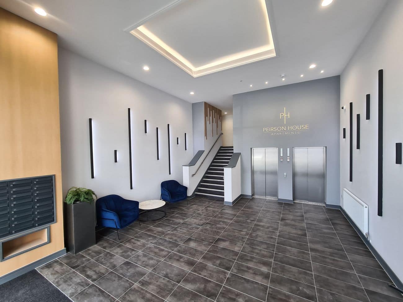 A communal entrance hall with letterboxes, a lift and a staircase.